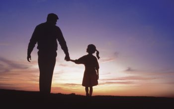 dad holding hand of daughter